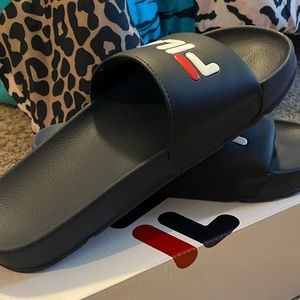Navy blue, red, and white Fila Slides